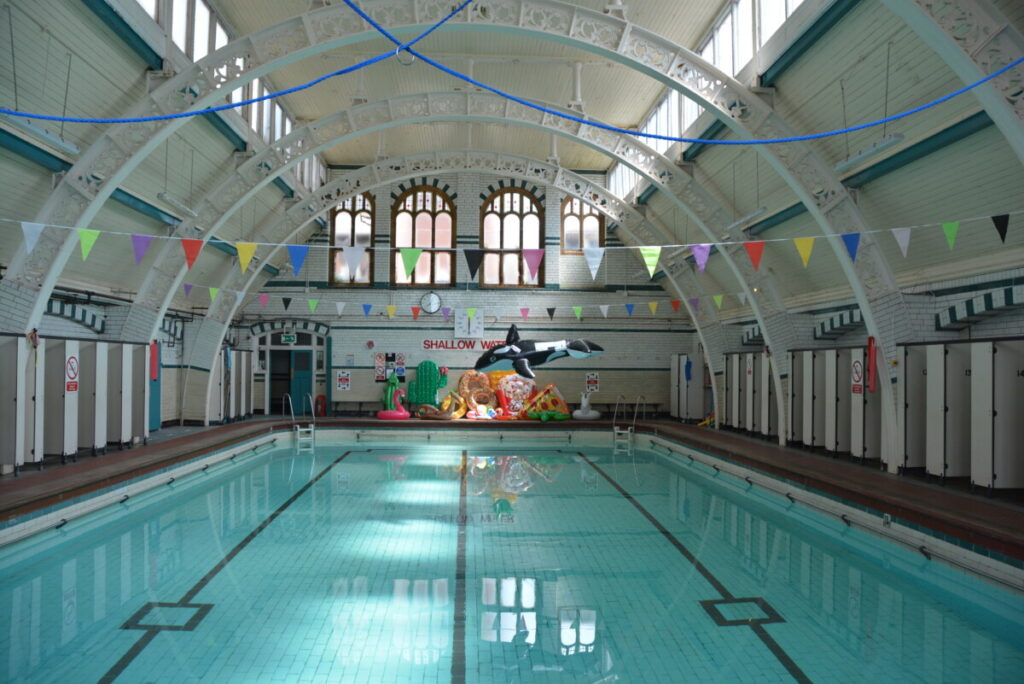 A photograph of Pool 2 with water in it and novelty inflatables balanced at the end of the pool.