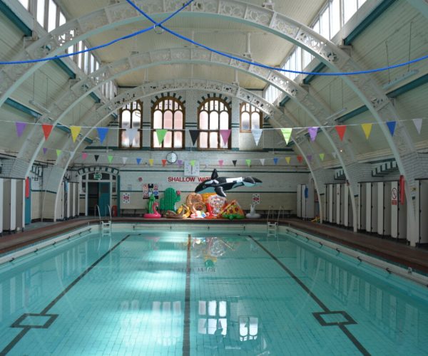 A photograph of Pool 2 with water in it and novelty inflatables balanced at the end of the pool.