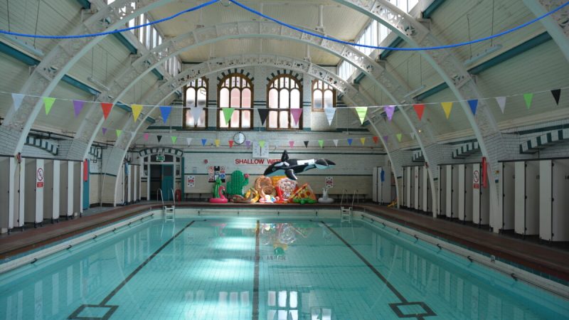 A photograph of Pool 2 with water in it and novelty inflatables balanced at the end of the pool.
